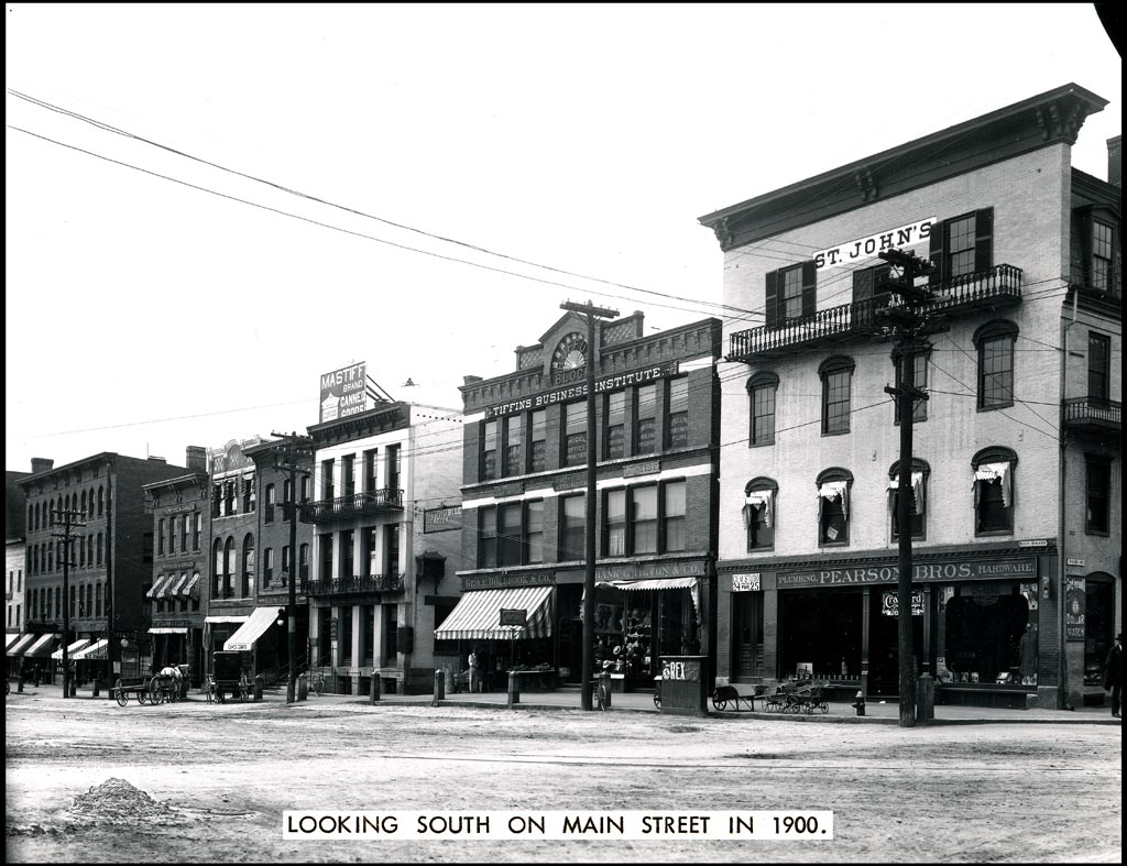 Historic photograph of Main Street in Keene, New Hampshire, around 1900, with period storefronts.